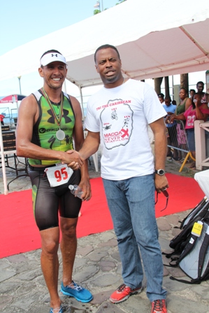 Deputy Premier of Nevis and Minister of Sports Hon. Mark Brantley greets decorated Triathelete Chris McCormack, winner of the first ever MaccaX Nevis International Triathlon held on Nevis on November 16, 2013